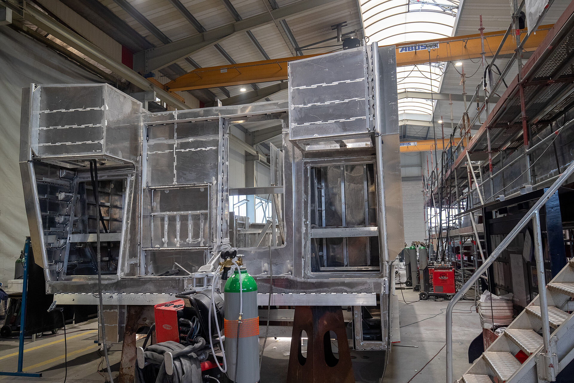 In einer Werfthalle liegt, auf dem Kopf liegen, der Aluminium-Rohbau des Aufbaus eines Seenotrettungskreuzers.